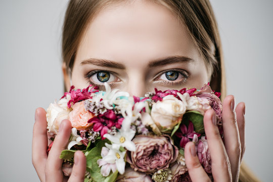 Beautiful girl with a mask of flowers