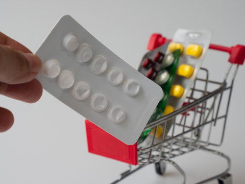 Picking medicine from he basket of shopping cart is obvious. The concept is for treatment and medication by using allopathic medicine.