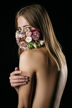 Beautiful girl with a mask of flowers