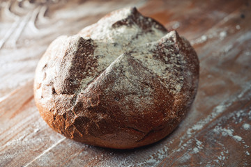 Traditional bread with a crust on a wooden board