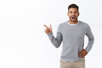 Fascinated speechless and happy young dreamy bearded guy talking about great opportunity, discuss...
