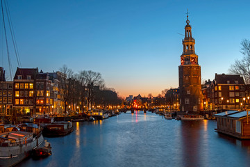 Fototapeta premium City scenic from Amsterdam with the Montelbaan Tower in the Netherlands at sunset