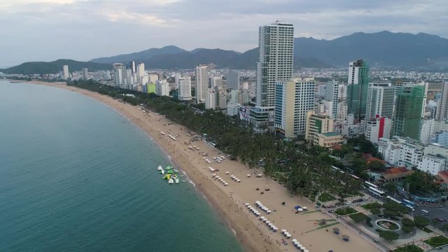 Aerial view of Nha Trang beach, six-kilometre stretch of beautiful coastline with white sandy beaches, clear water with an abundance marine life and thriving reefs, verdant mountain ranges at each end