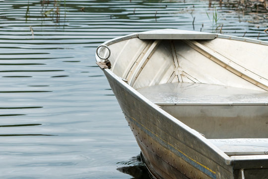 aluminium rowboat on the water tied up