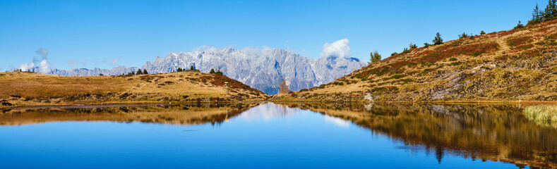 Autumn alpine Kleiner Paarsee or Paarseen lake, Land Salzburg, Austria. Alps Hochkonig rocky mountain group view in far.