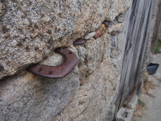 A horseshoe is inserted into a wall made of stone, Camino de Santiago, Way of St. James, Journey from Dumbria to Muxia, Fisterra-Muxia way, Spain