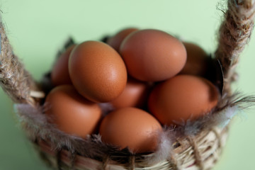 basket with eggs on a green background