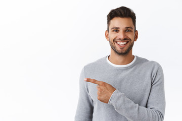 Close-up cheerful good-looking outgoing bearded modern man in grey sweater asking out for coffee,...