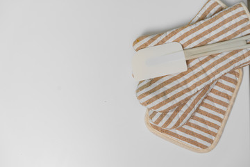 Kitchen tools, glove and potholder for hot tableware, silicone spatula, white background