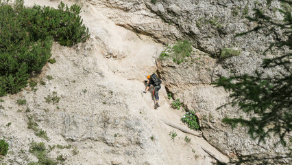 Going through a difficult trail in the full inventory located in the gorge. Dolomites in the Alps.