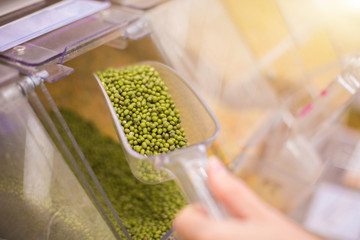 Woman buying mash in grocery farm- market. Mash, Lu-Daw, Asian Beans, Golden Beans. The legume crop originates from India.
