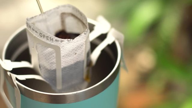 How to making coffee drip with hot water, roasted coffee beans on filter, Hot water pouring to roasted coffee for fresh drip coffee. Industrial food and drink concept.
