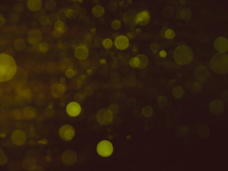 Bokeh light abstract vintage color blurred on black background. Sparkling magical dust particles. Magic concept.