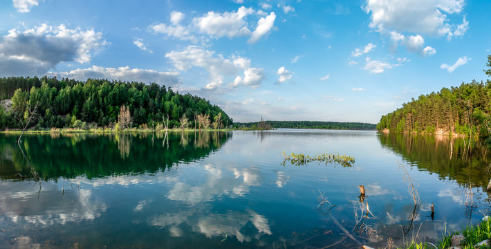 Russia, Moscow region, Dzerzhinsky - forest lake in the evening. Reflection clouds in lake.