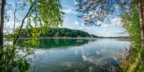 Russia, Moscow region, Dzerzhinsky - forest lake in the evening. Reflection clouds in lake.