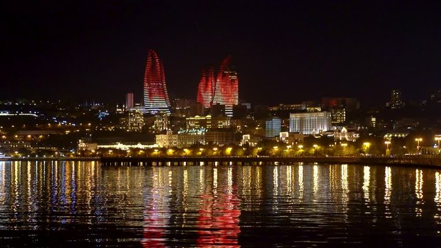 Baku, Azerbaijan - July 2019: Flame Towers in night cityscape. The facades of Flame Towers function as large display screens with the use of more than 10,000 high-power LED luminaires
