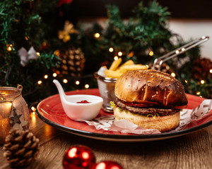 beef burger served with french fries and ketchup