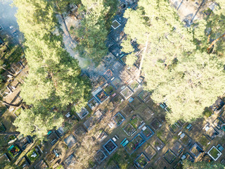 Fire in a forest cemetery. Smoke envelops conifers. Aerial drone view.