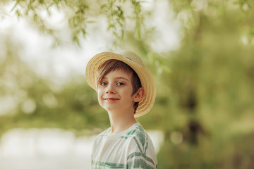 boy fisherman in a hat on the river