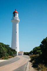 White Lighthouse in front of blue sky