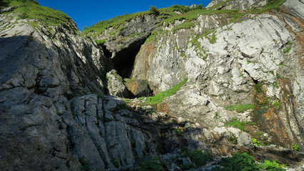Rocky mountain slope covered with grass in the Alps