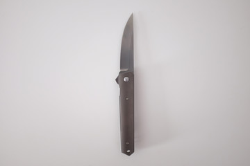 Metal folding knife on a white background