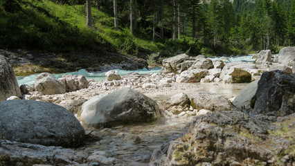 Rapid river flowing through the valley in the Italian Dolomites