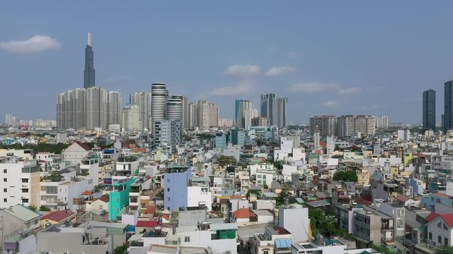 Aerial video of interesting rooftops of quirky high density residential area in Southeast Asia on a clear sunny day. Camera moves downwards from high angle
