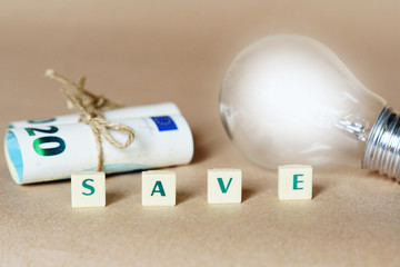 light bulb and money - saving money and energy concept