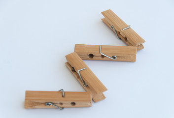 Wooden clothes pins in a zig zag shape. Isolated on a white background. Close up