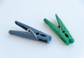 Close up view of a clothes pegs on white background with clipping path. Green and blue clothes pins