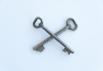 Two crossed retro keys isolated on white background. Top view