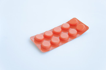 Orange package of pills isolated on white background. Healthcare concept