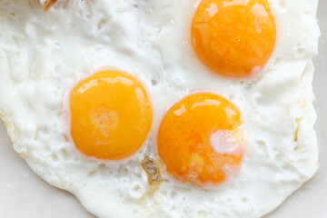 Three fried eggs for healthy breakfast.