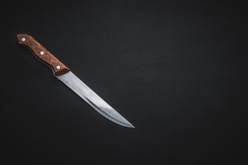 Kitchen knife on black background. Selective focus