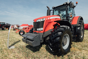 red tractor in a field at an agricultural exhibition in summer