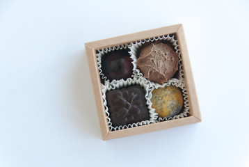 Handmade chocolate candies in a gift square box. Top view