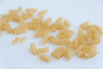 Close up view of fusilli swirl italian pasta. Isolated on white background