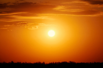 Orange sun at sunset. Clouds, landscape, screensaver, background