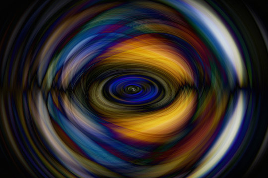 Abstract image with swirls in blue and orange tones that looks like an eye on black background