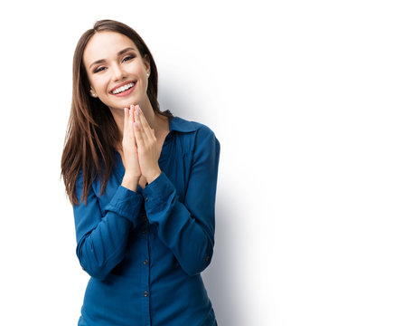 Portrait Of Happy Gesturing Smiling Brunette Lovely Woman In Casual Smart Blue Clothing, Isolated Against White Background. Caucasian Brunette Model In Emoshions And Feeling Concept.