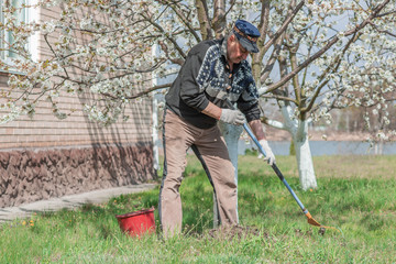 Senior man with working at garden, hobby time for older people