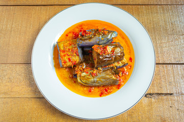 Terong balado on white plate. Indonesian food made from fried eggplants and cooked with red chili. 