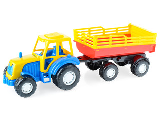 Children's plastic truck with a trailer on a white background, close-up. Bright, toy car for children. Educational games for children. Children's leisure and games