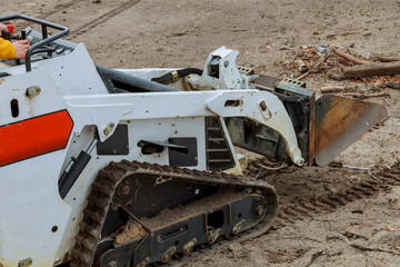 Mini bulldozer with earth doing landscaping works