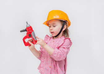 On white background with copy space. A little girl with ponytails in a checked shirt on a white background. The girl listens to music through headphones.  Distance learning