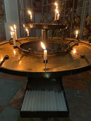 Fire in the church, burning candles. Candles flame close up. Place for candles