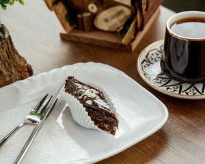 chocolate baklava with nuts and a cup of tea