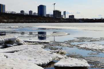 ice on the river against the city on a sunny day
