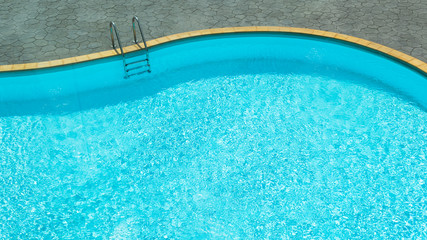 Swimming pool with blue water and stair
